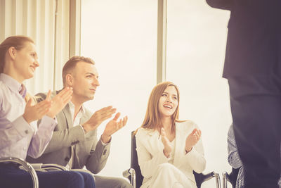 Business people clapping hands at meeting