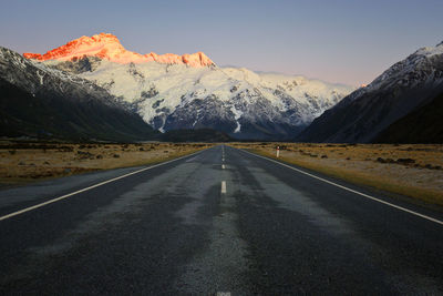 Road amidst mountains against sky