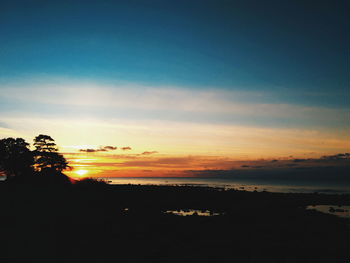 Scenic view of beach against sky during sunset