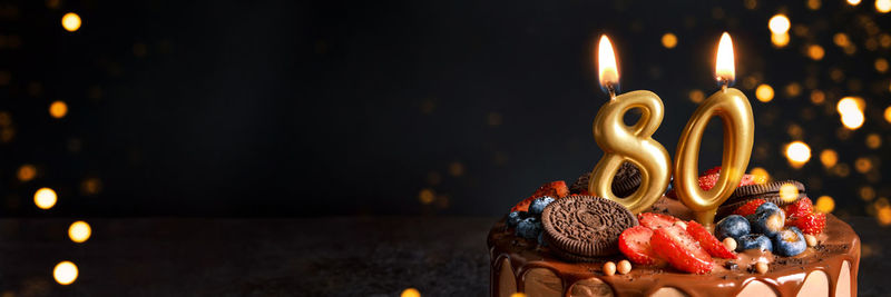 Close-up of illuminated candles on table