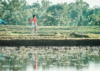 Full length of man standing by lake