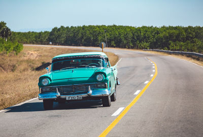 Vintage car on road against sky