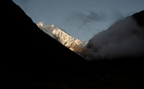 Smoke emitting from volcanic mountain against sky