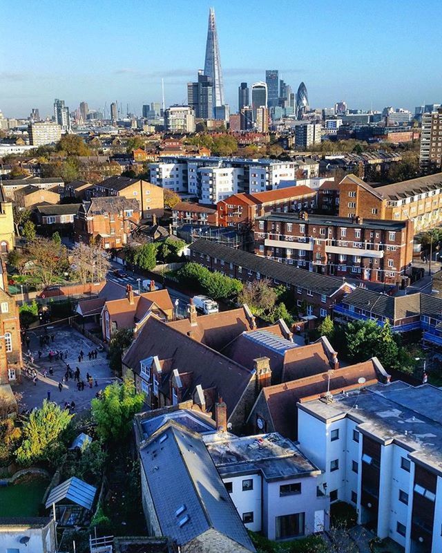 building exterior, architecture, built structure, city, cityscape, residential district, crowded, residential building, high angle view, residential structure, tower, skyscraper, tall - high, city life, sunlight, blue, clear sky, day, outdoors, capital cities