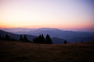 Scenic view of silhouette mountains against sky during sunset