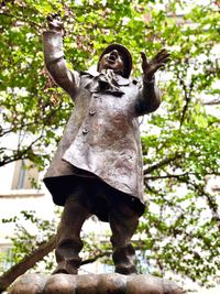 Low angle view of statue against tree