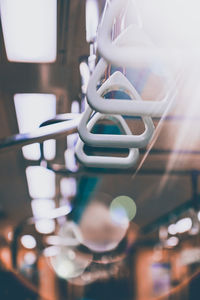 Close-up of electric lamp hanging in row