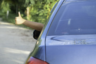 Reflection of hand on car mirror