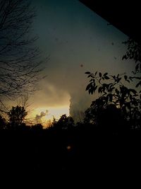 Low angle view of silhouette built structures against sky