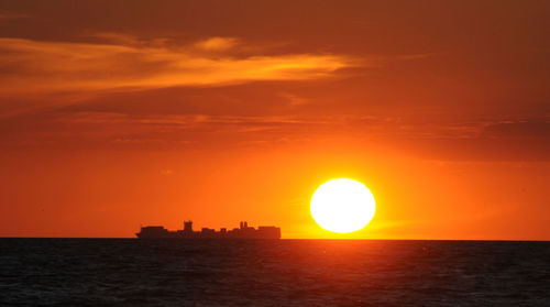 Scenic view of sea against orange sky