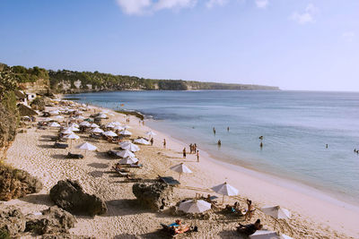 High angle view of people at beach against sky