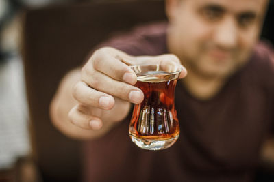 Close-up of hand holding glass of wine