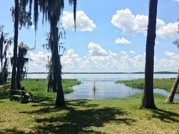 Scenic view of lake against cloudy sky