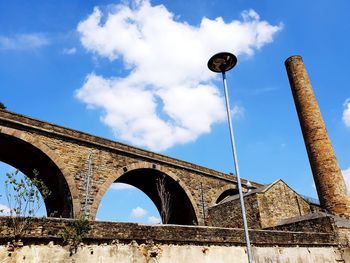 Low angle view of old bridge against sky