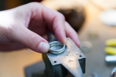 Close-up of human hand holding metal