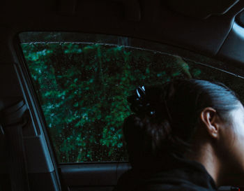 Rear view of man against window