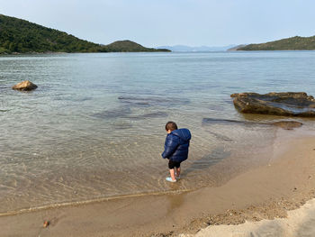 Full length of man on beach against sky