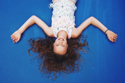 Portrait of girl lying on trampoline