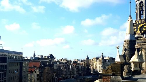 Buildings against cloudy sky