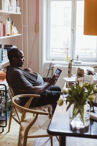 Male entrepreneur using digital tablet at home office