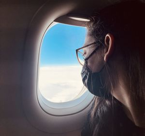 Close-up portrait of airplane wing seen through window