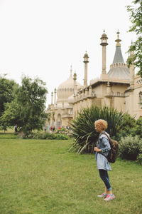 Side view of woman standing at royal pavilion