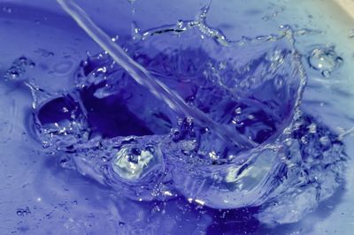Close-up of water splashing in glass