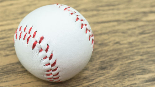 Close-up of baseball on wooden table