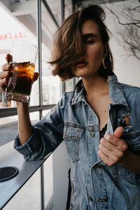 Midsection of a woman drinking glass