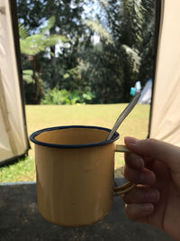 Midsection of person holding coffee cup