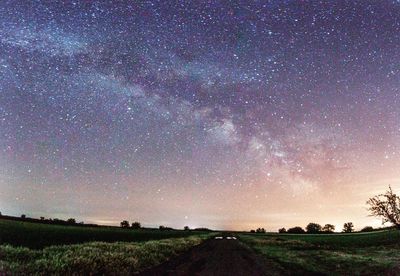 Scenic view of field against sky at night