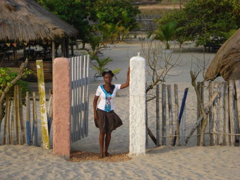 Portrait of smiling woman standing on beach