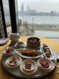 High angle view of chinese dim sum with the background of victoria harbour 