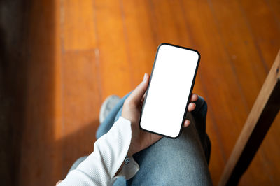 Midsection of woman using mobile phone