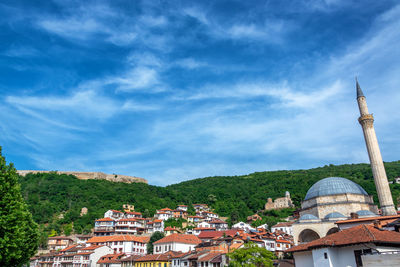 View of townscape against cloudy sky