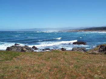 Scenic view of sea against clear blue sky