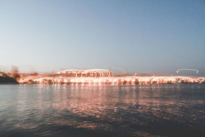 Scenic view of lake against clear sky during winter