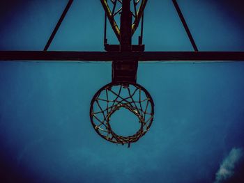 Low angle view of basketball hoop against blue sky