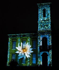 Low angle view of illuminated building at night