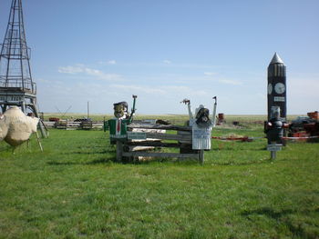 Sculpture on field against sky