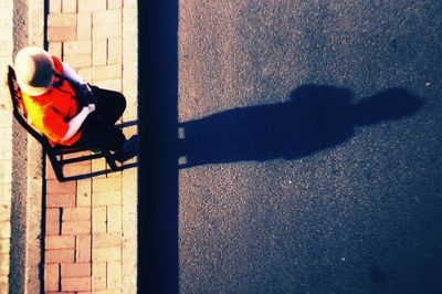 High angle view of man playing with shadow