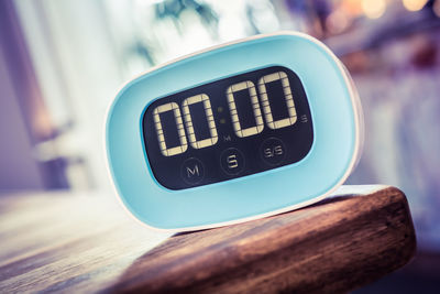 Close-up of digital clock on table