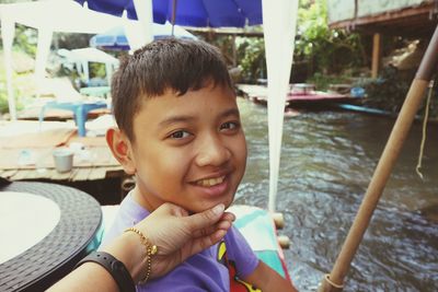 Portrait of cute boy smiling water