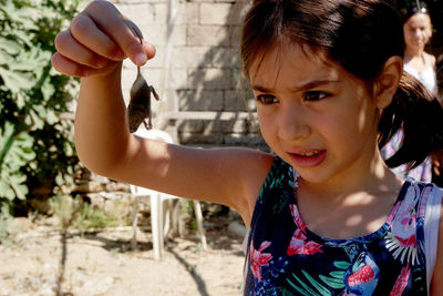 Close-up of girl holding mouse