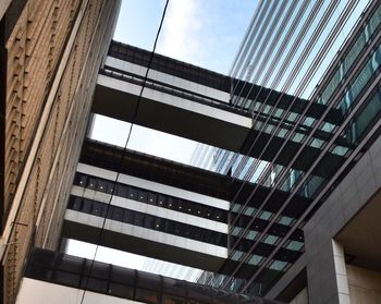 Low angle view of glass building against sky