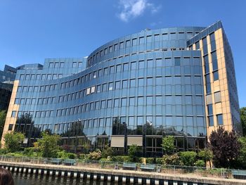 Low angle view of modern buildings against clear blue sky