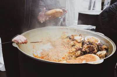 Midsection of man preparing food