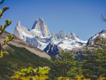 Scenic view of snowcapped mountains against clear sky