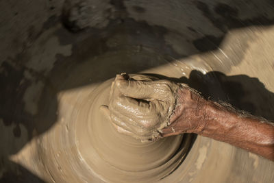 Cropped hand of man working at workshop