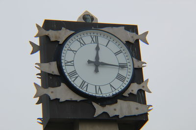 Low angle view of clock on wall